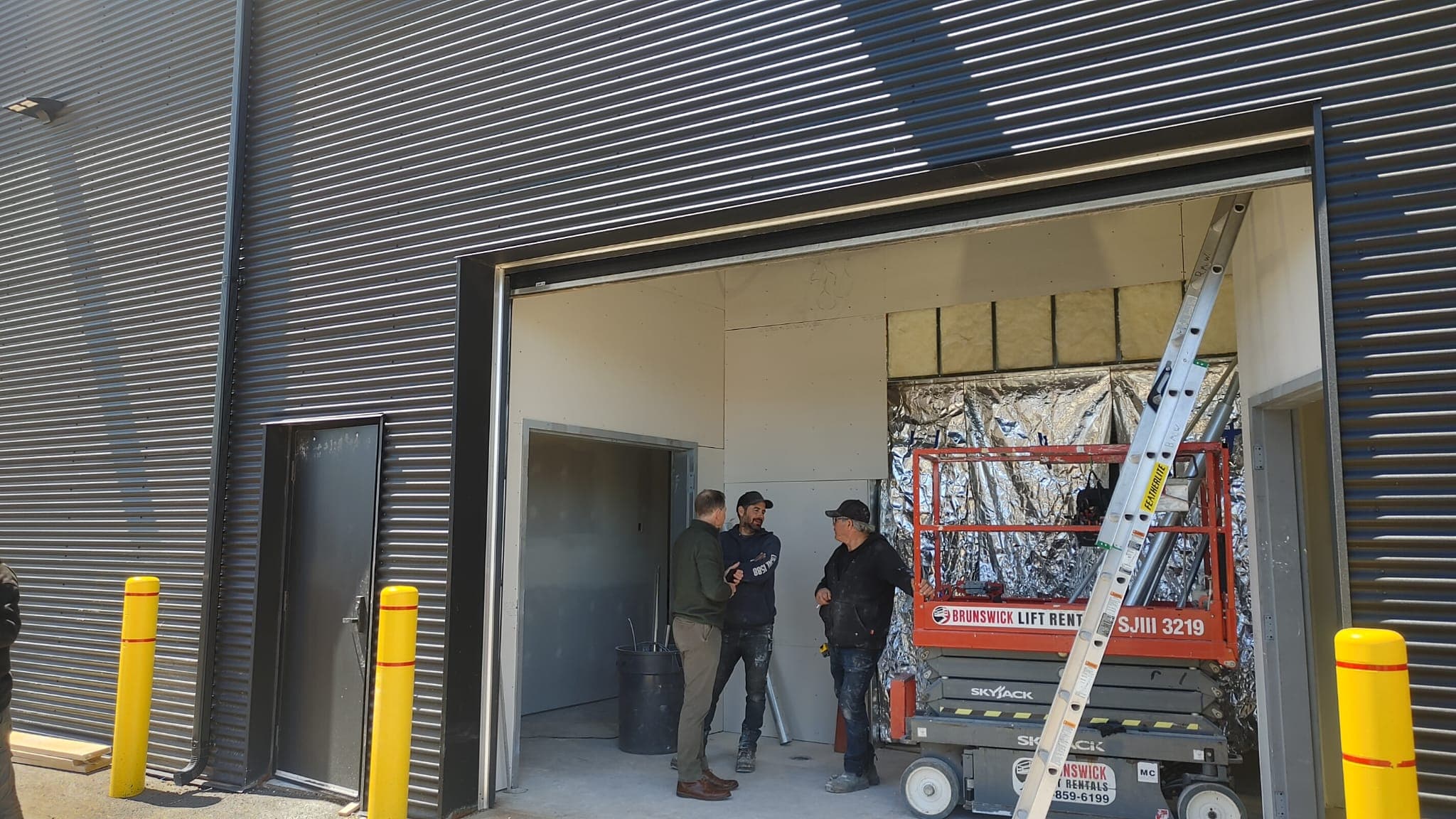 Project team meeting at the facility loading bay