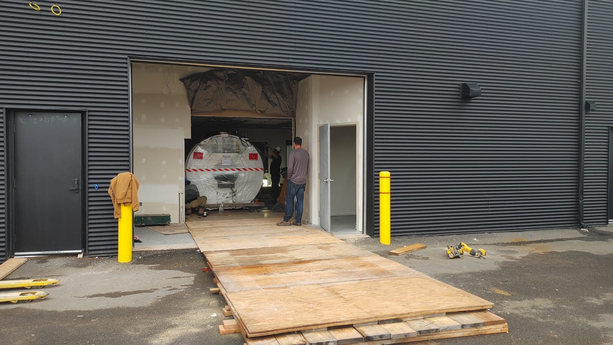 MRI magnet moved into the scan room along a plywood ramp through the loading bay