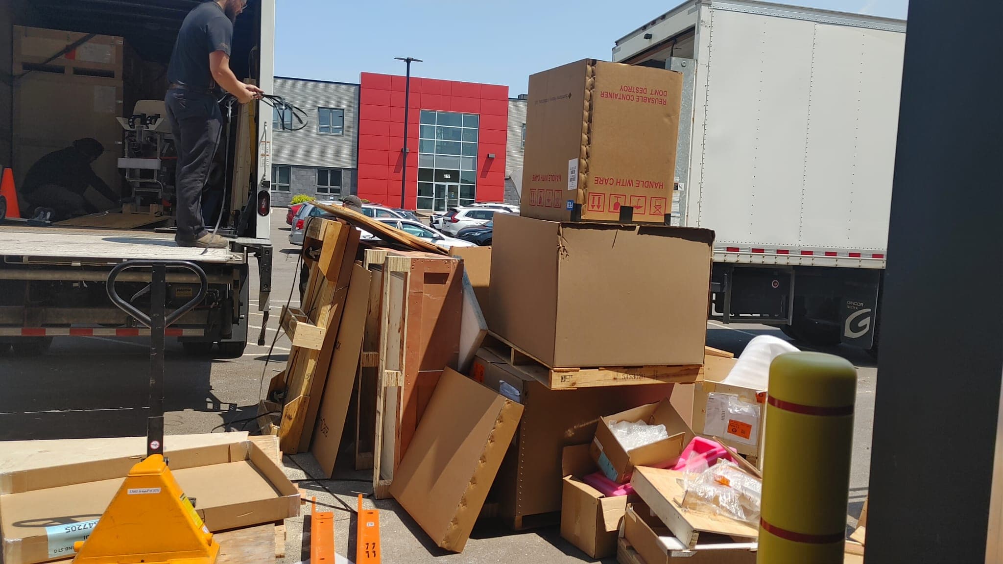 Crated MRI components being unloaded on delivery day