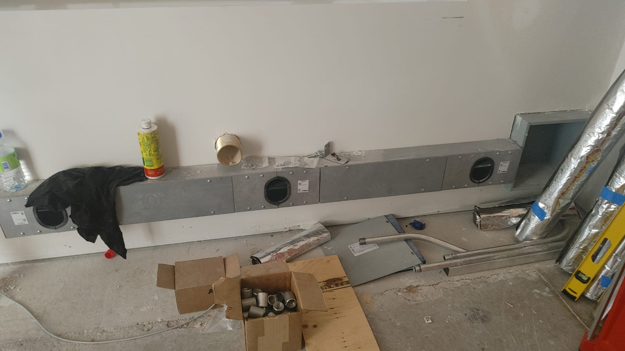 HVAC ductwork and registers installed along an interior wall