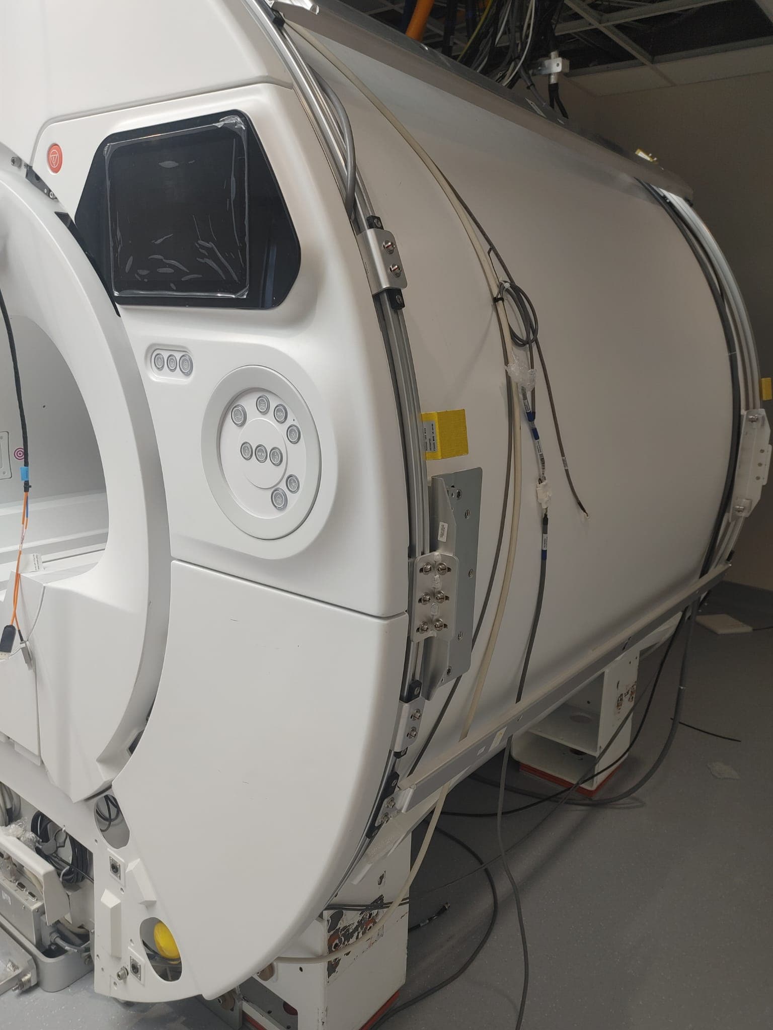 Detail of the MRI scanner bore with in-bore display and patient controls