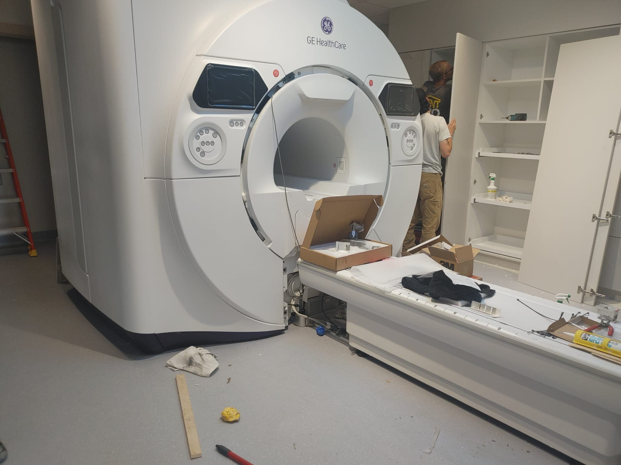 GE HealthCare MRI in position with its patient table as room finishing continues