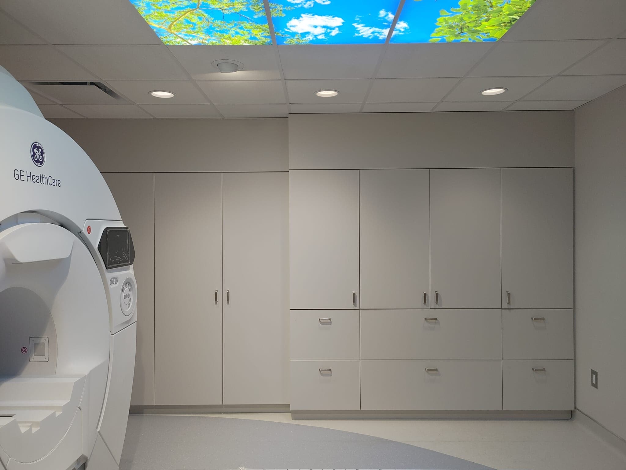 Finished scan room with GE HealthCare MRI, built-in storage and sky ceiling