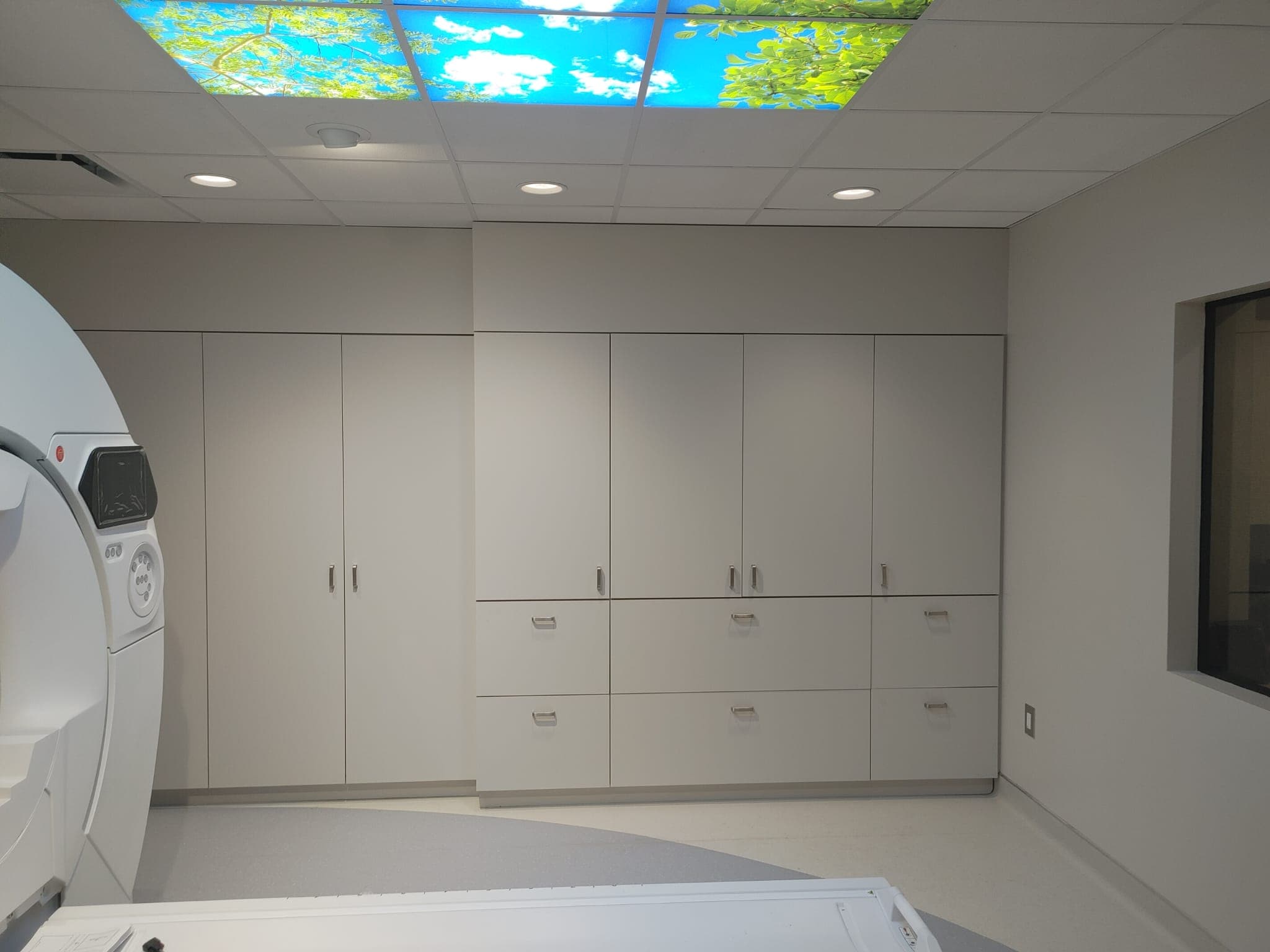 MRI suite complete with the control-room window and storage millwork in place